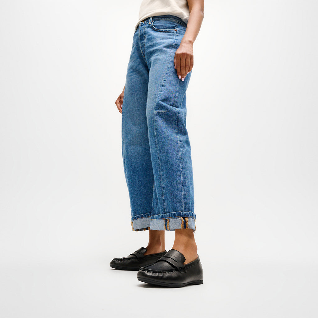 Woman wearing FitFlop DELICATO Leather Loafers with premium leather construction, ergonomic cushioning, and timeless loafer styling.