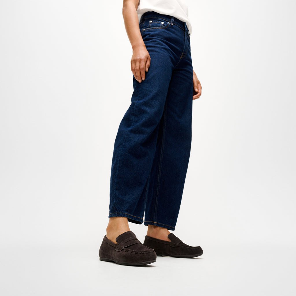 Woman wearing FitFlop DELICATO Suede Loafers with premium suede construction, ergonomic cushioning, and timeless loafer styling.
