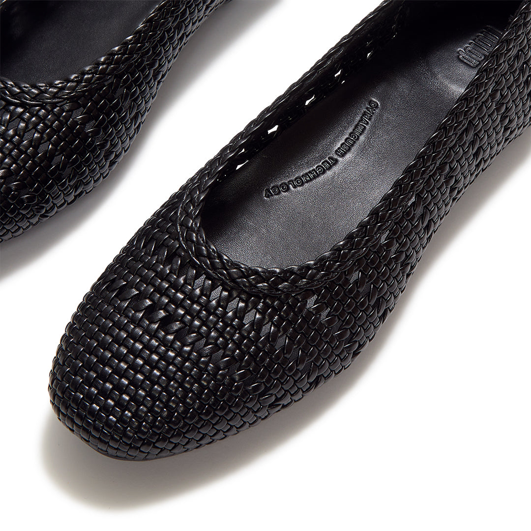 Close-up of FitFlop DELICATO Woven PU Ballerinas showcasing the woven faux-leather texture and refined craftsmanship.