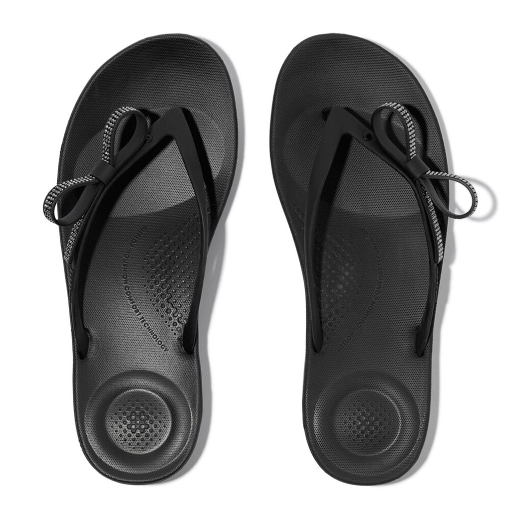 iQUSHION Glitz-Bow flip-flops with cushioned footbed, anatomically shaped straps, delicate bow detail, waterproof and lightweight.