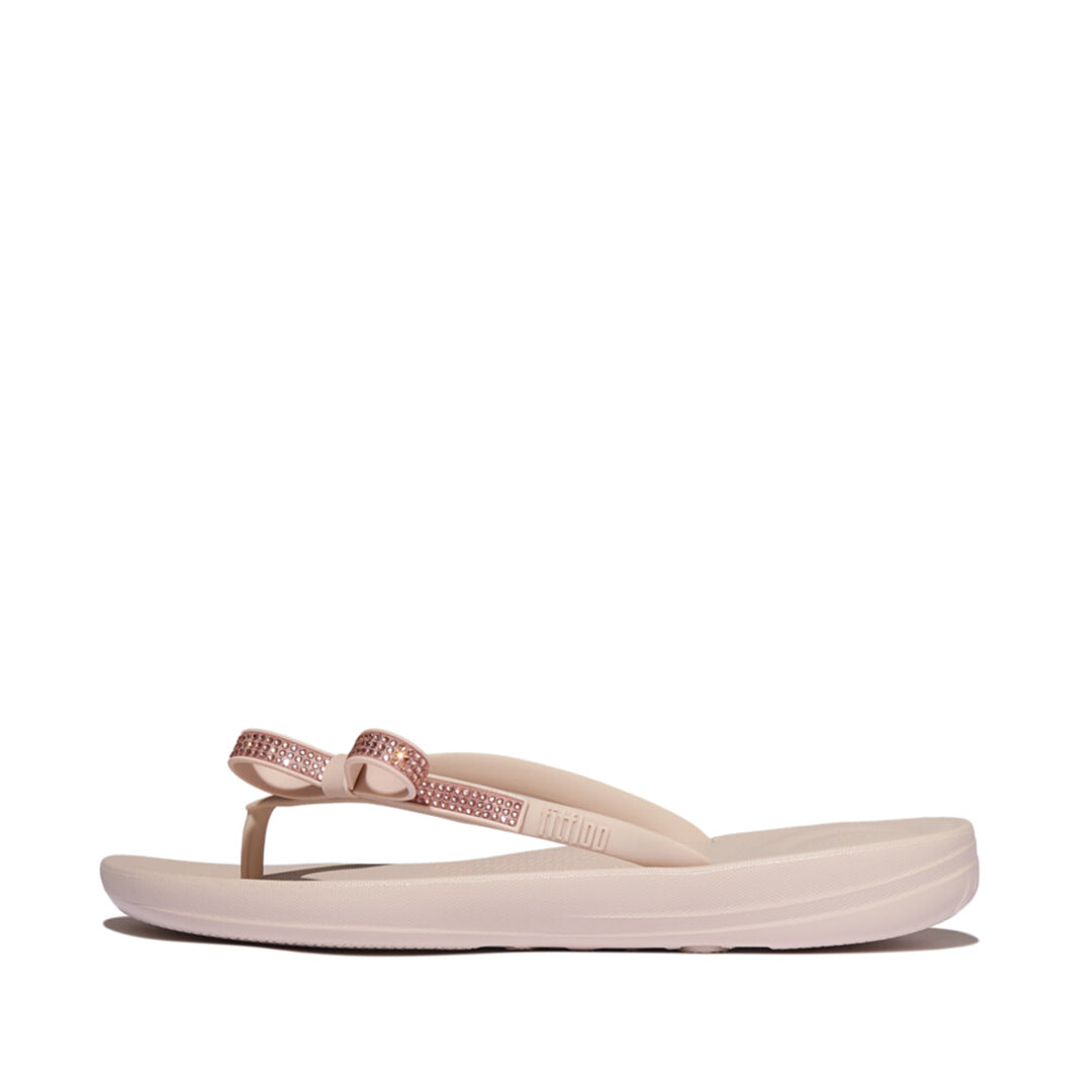 iQUSHION Glitz-Bow flip-flops with cushioned footbed, anatomically shaped straps, delicate bow detail, waterproof and lightweight.
