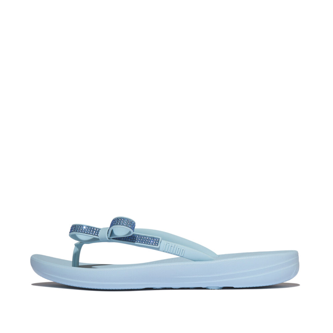 iQUSHION Glitz-Bow flip-flops with cushioned footbed, anatomically shaped straps, delicate bow detail, waterproof and lightweight.