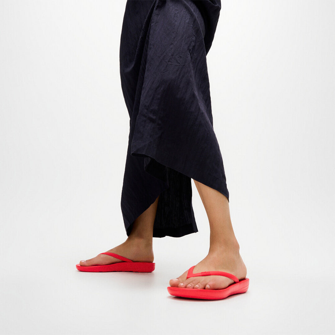 Ergonomic FitFlop iQushion flip-flops with impact-absorbing cushioning, contoured support, and slip-resistant grip, designed for all-day comfort. APMA-approved.