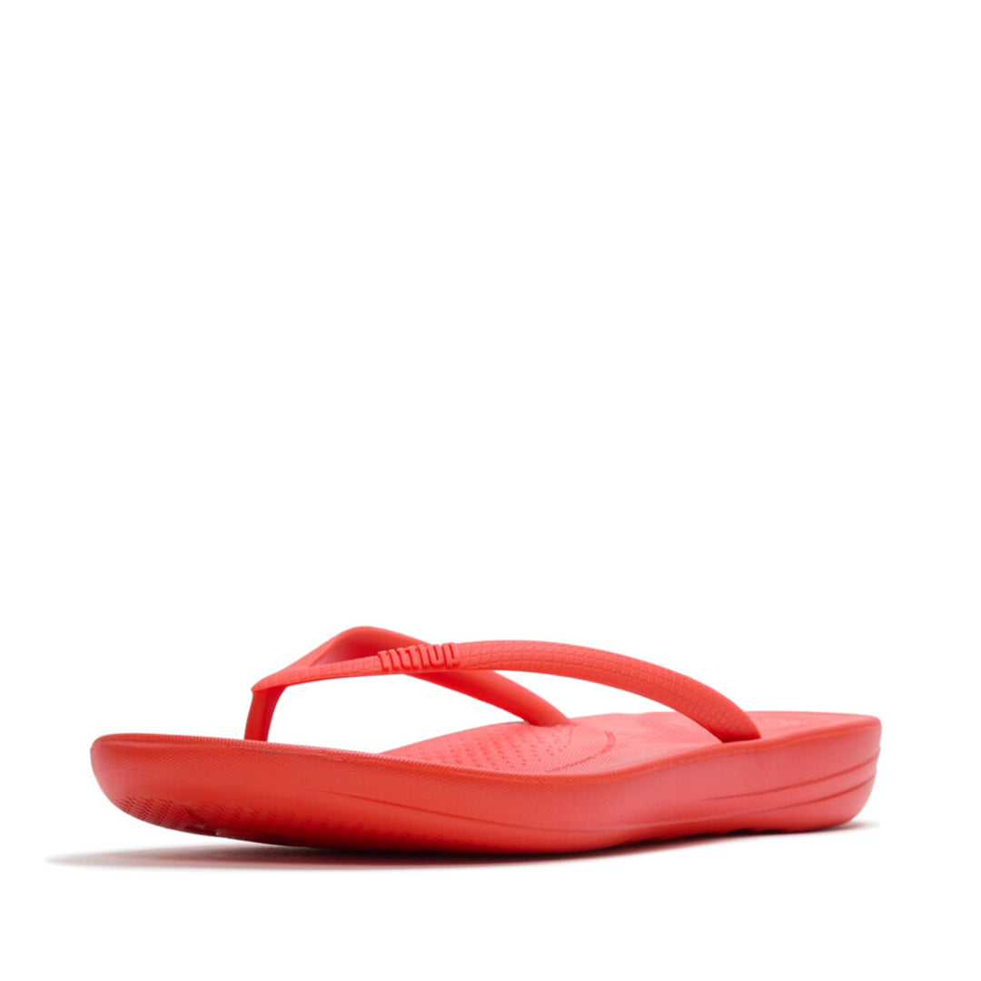 Ergonomic FitFlop iQushion flip-flops with impact-absorbing cushioning, contoured support, and slip-resistant grip, designed for all-day comfort. APMA-approved.