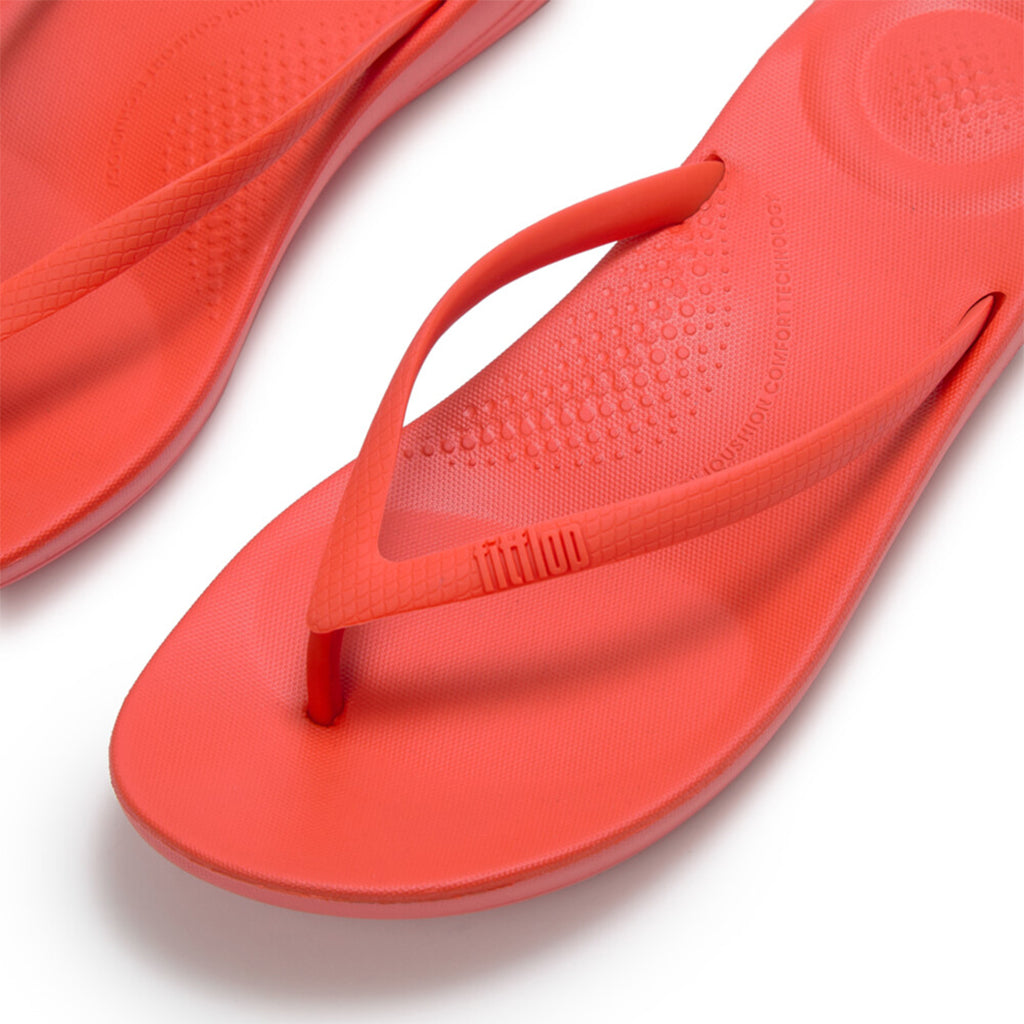 Ergonomic FitFlop iQushion flip-flops with impact-absorbing cushioning, contoured support, and slip-resistant grip, designed for all-day comfort. APMA-approved.