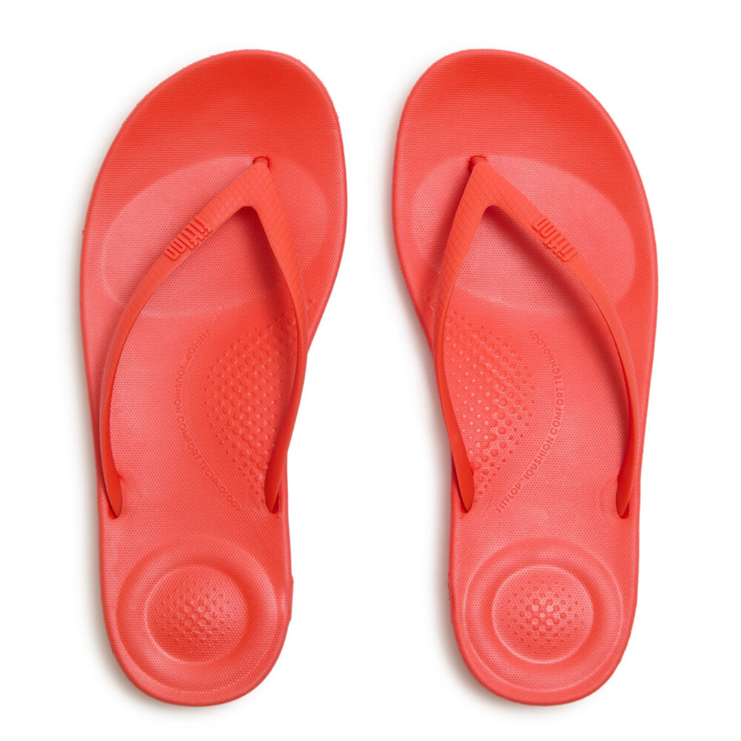 Ergonomic FitFlop iQushion flip-flops with impact-absorbing cushioning, contoured support, and slip-resistant grip, designed for all-day comfort. APMA-approved.