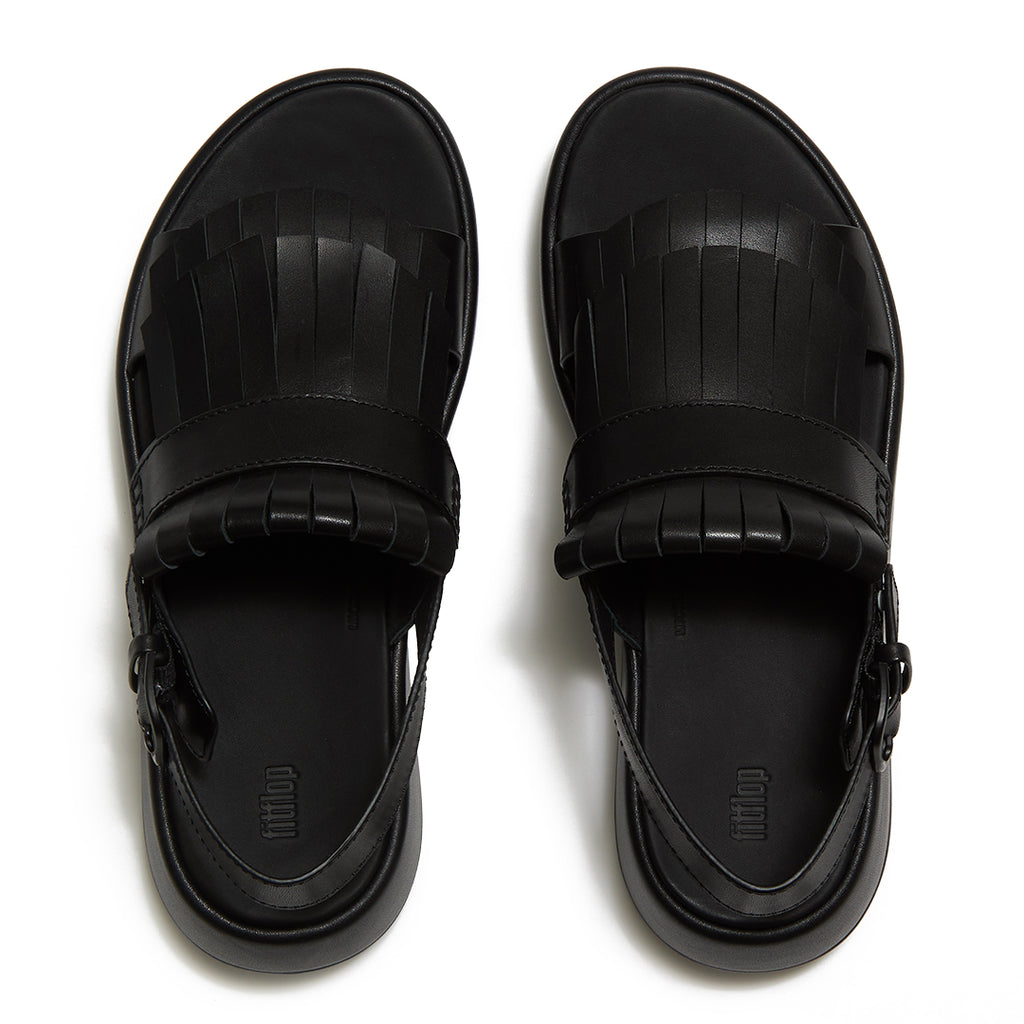 Top view of FitFlop F-MODE Fringe Sandals highlighting premium leather straps, decorative fringe trim, toe-post design, and adjustable ankle buckle.