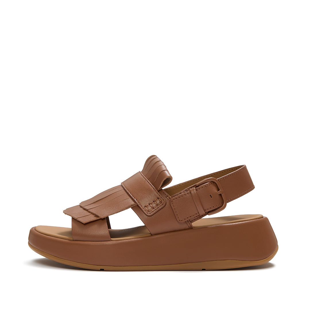 FitFlop F-MODE Fringe Sandals featuring premium leather straps, loafer-inspired fringe detailing, adjustable ankle buckle, and a chunky cushioned sole.