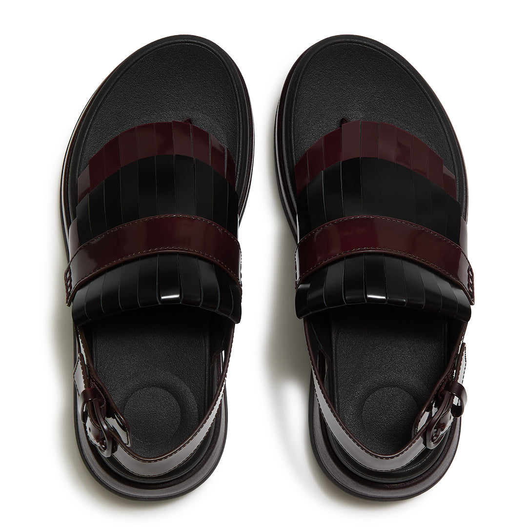 Top view of FitFlop F-MODE STACK Leather Fringe Sandals highlighting the tassel-inspired trim, toe-post design, and adjustable ankle strap.