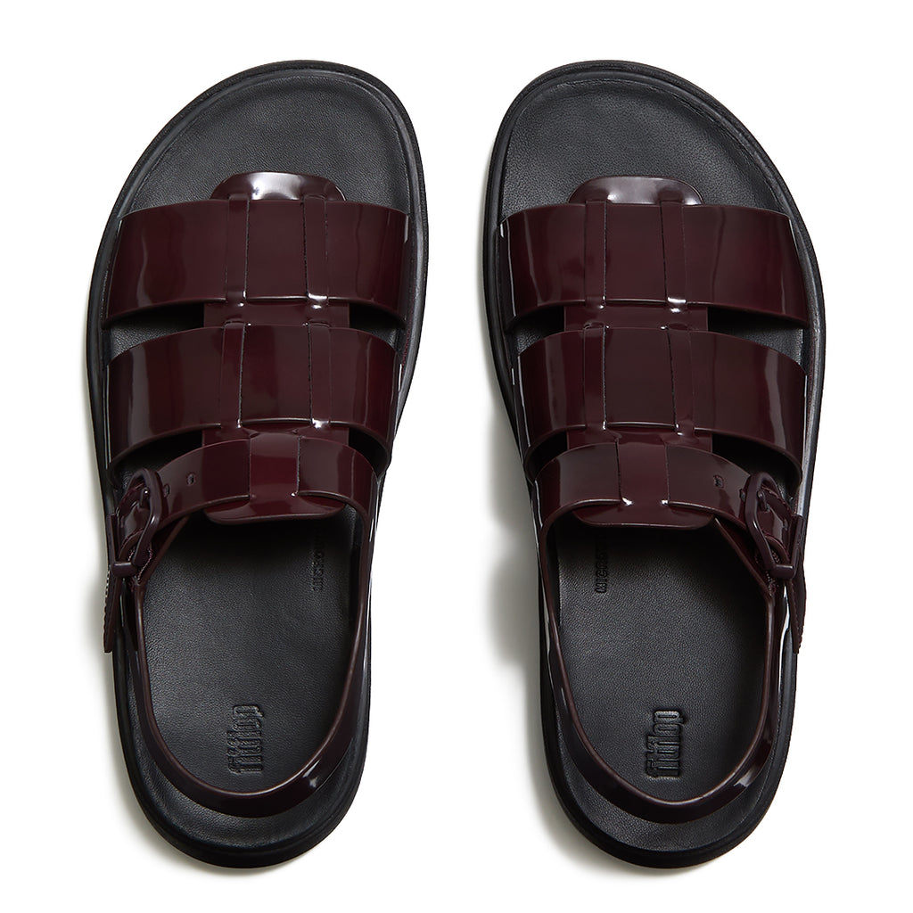 Woman wearing FitFlop GEN-FF Brushed Leather Fisherman Sandals with premium brushed leather, adjustable ankle strap, and ergonomic comfort.