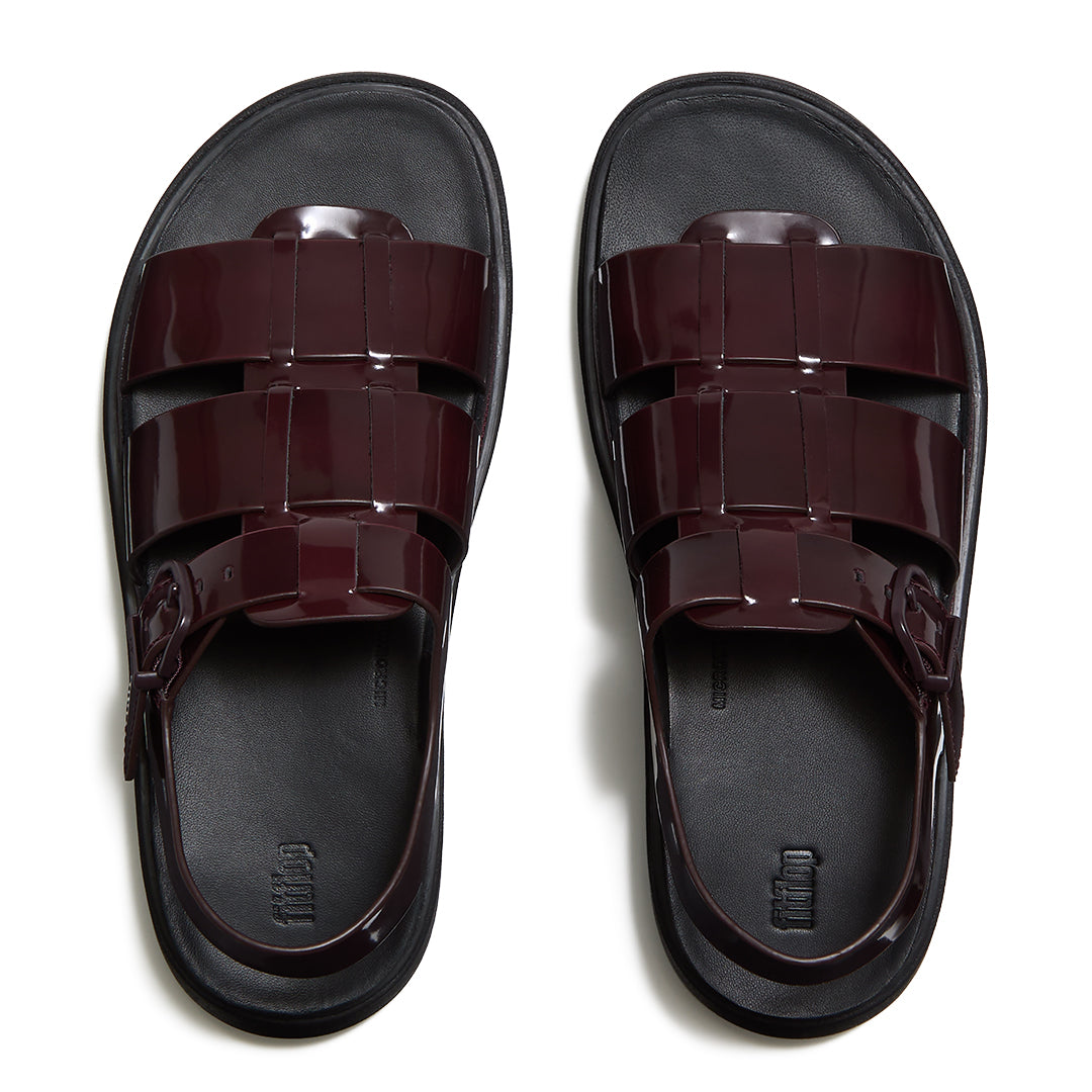 Woman wearing FitFlop GEN-FF Brushed Leather Fisherman Sandals with premium brushed leather, adjustable ankle strap, and ergonomic comfort.