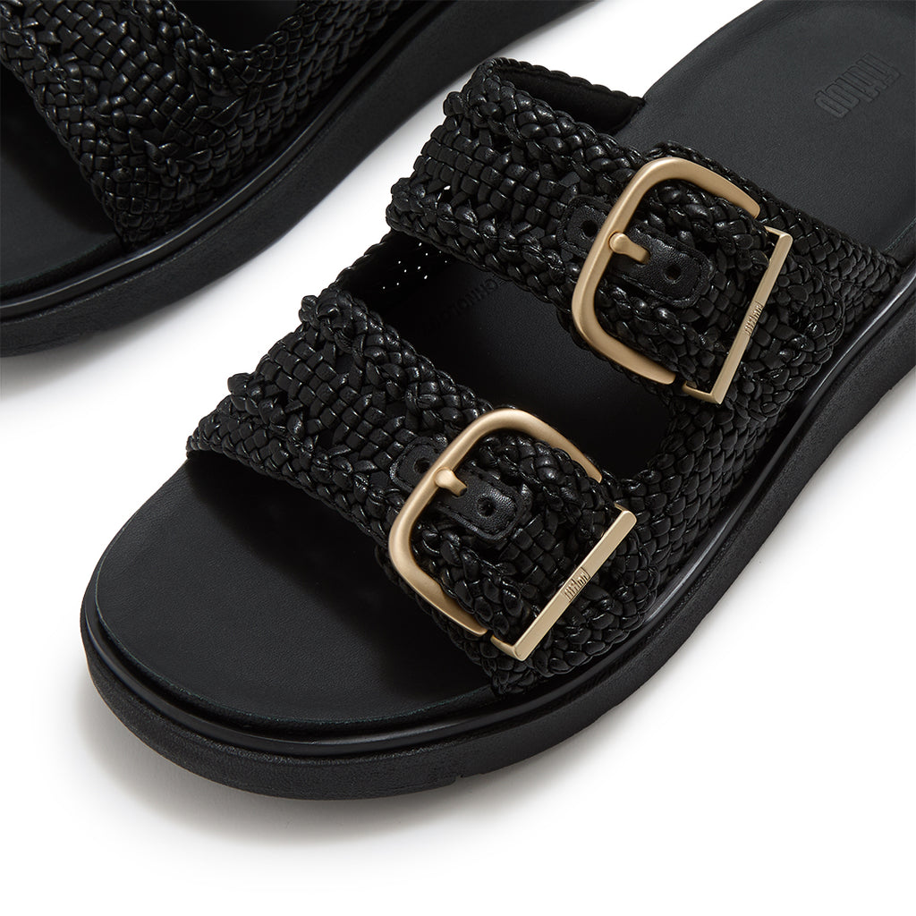 Close-up of FitFlop GEN-FF Woven Two-Bar Slides showcasing the twisted woven faux-leather texture, tonal grosgrain trim and buckle fastening.