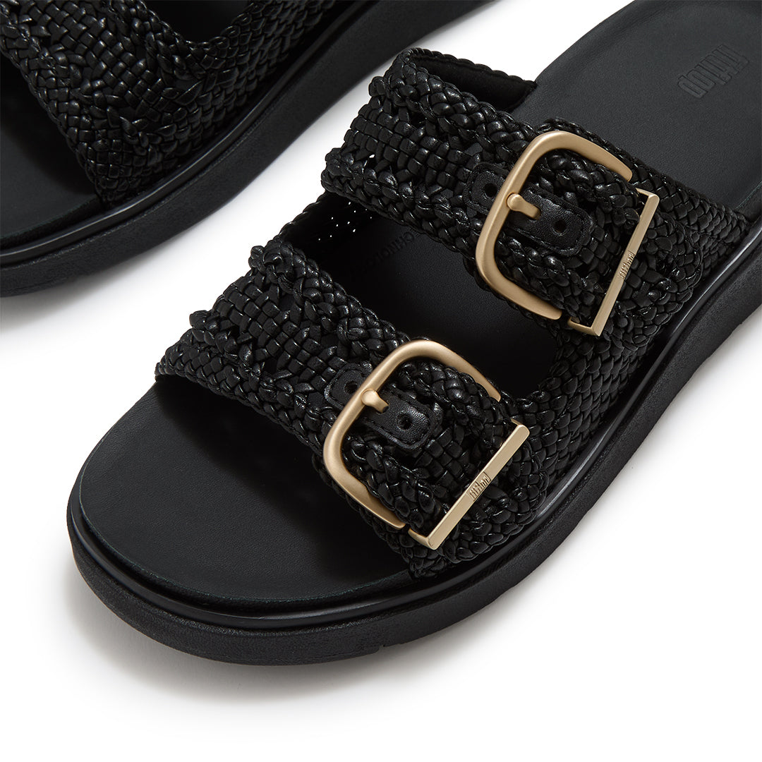 Close-up of FitFlop GEN-FF Woven Two-Bar Slides showcasing the twisted woven faux-leather texture, tonal grosgrain trim and buckle fastening.