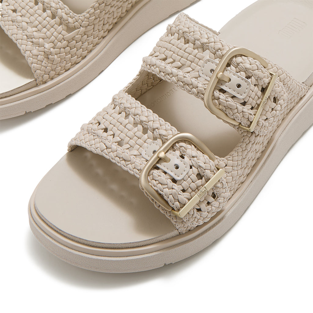 Close-up of FitFlop GEN-FF Woven Two-Bar Slides showcasing the twisted woven faux-leather texture, tonal grosgrain trim and buckle fastening.