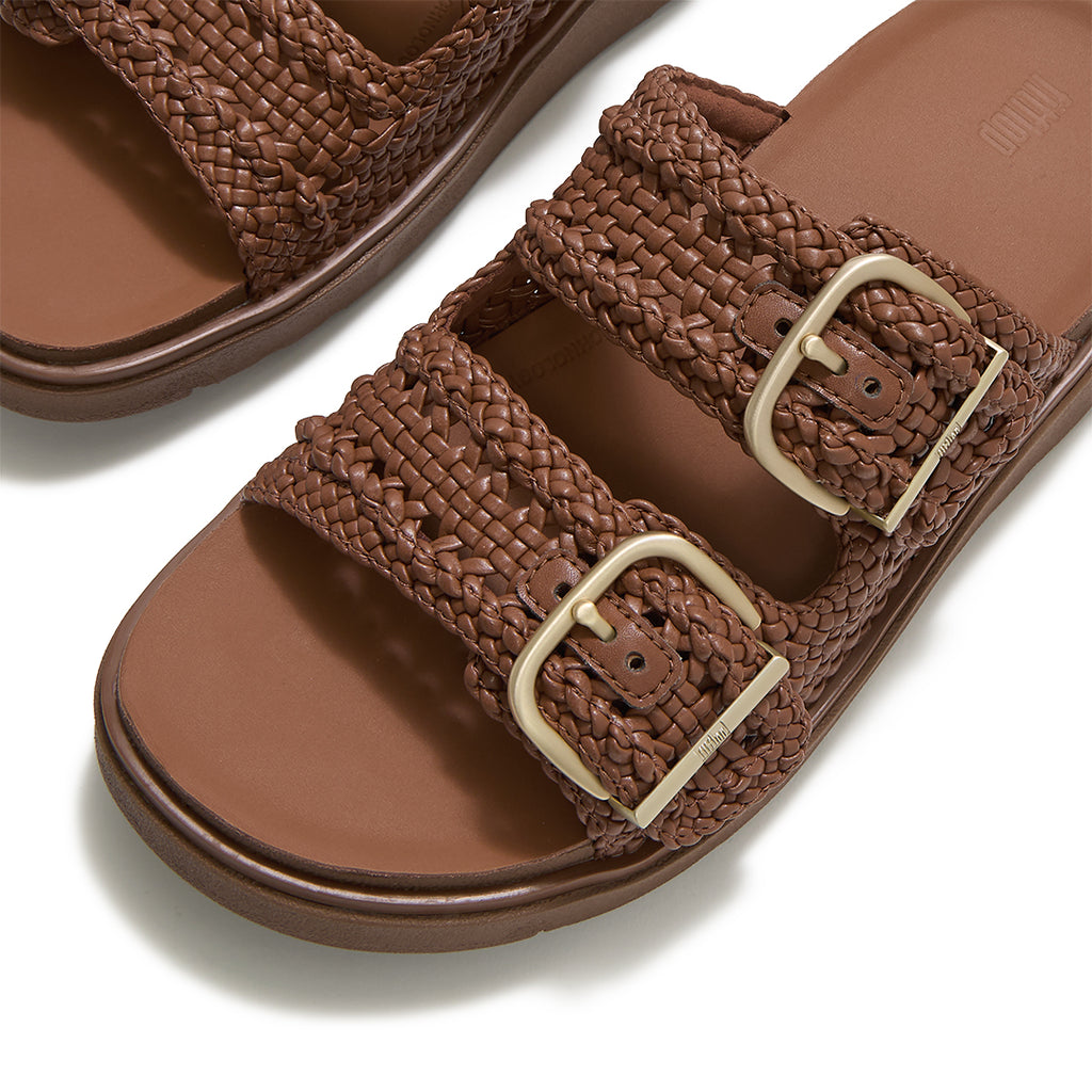 Close-up of FitFlop GEN-FF Woven Two-Bar Slides showcasing the twisted woven faux-leather texture, tonal grosgrain trim and buckle fastening.