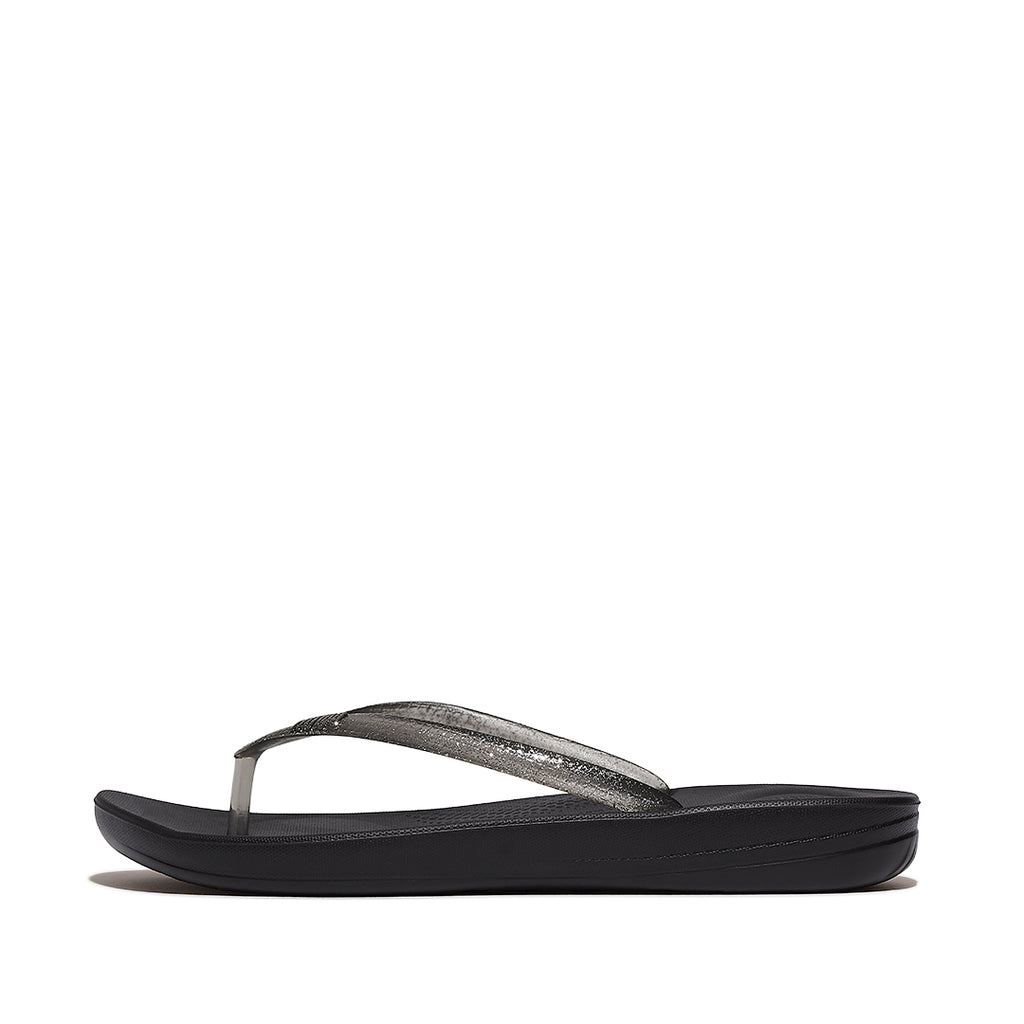 Side view of FitFlop iQUSHION Glitter Flip-Flops showcasing shimmering straps, slim lightweight sole, and ergonomic design.