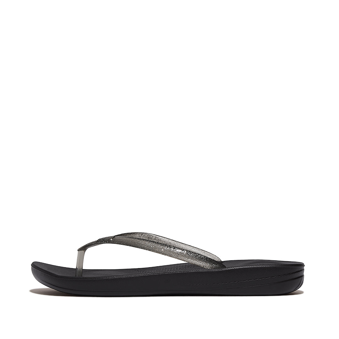 Side view of FitFlop iQUSHION Glitter Flip-Flops showcasing shimmering straps, slim lightweight sole, and ergonomic design.