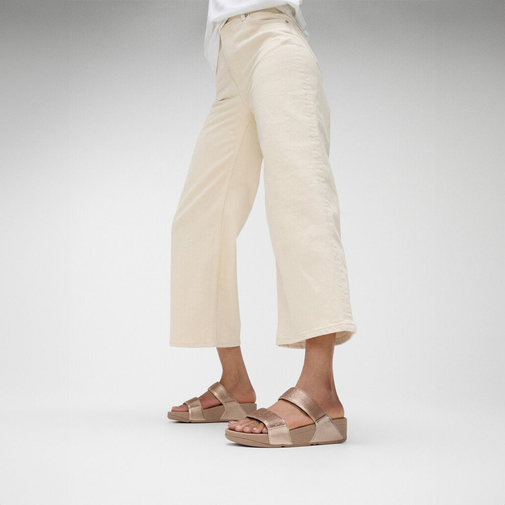 LULU sequin slides with padded uppers, Microwobbleboard™ cushioned footbed, metallic side panels, and sparkling sequins.