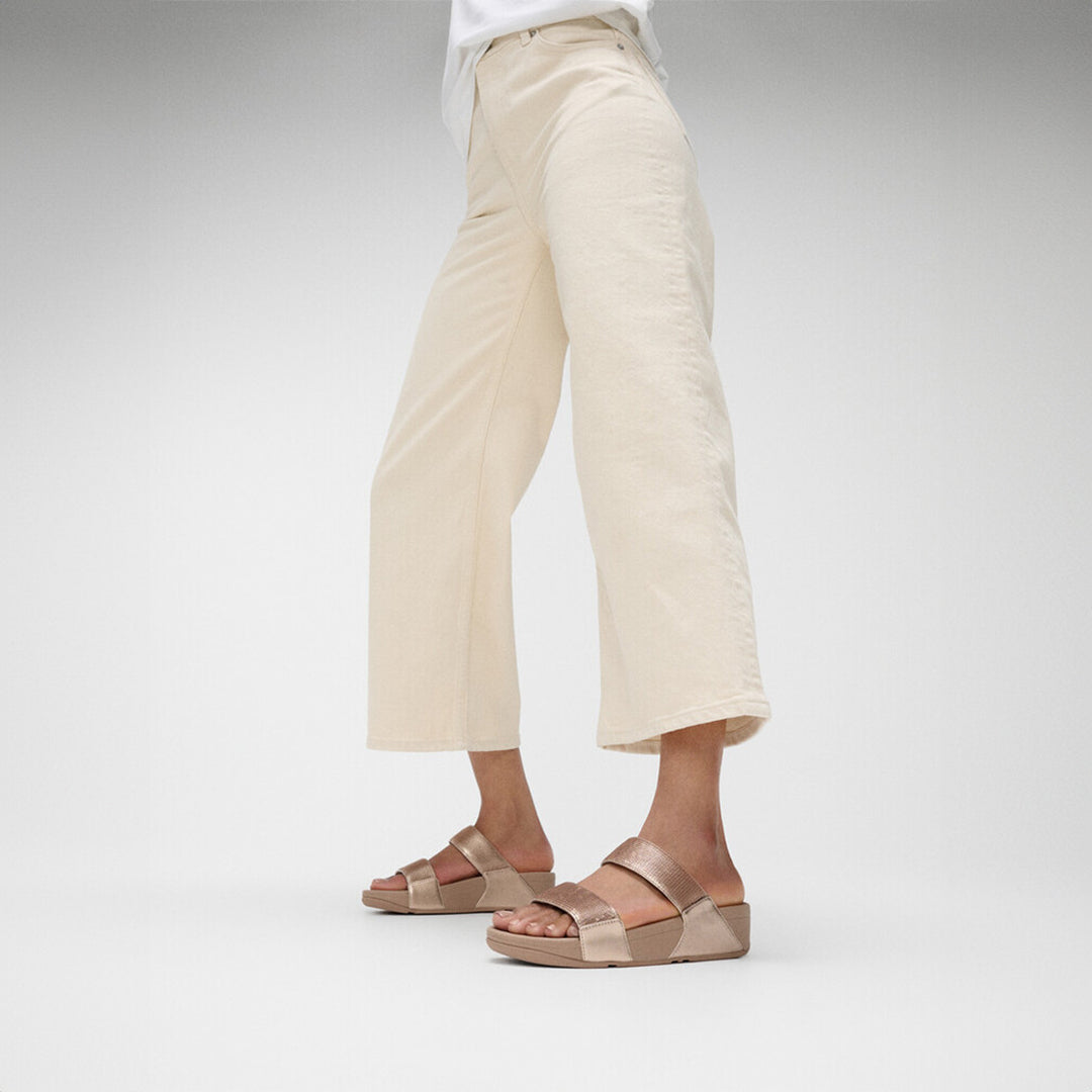 LULU sequin slides with padded uppers, Microwobbleboard™ cushioned footbed, metallic side panels, and sparkling sequins.