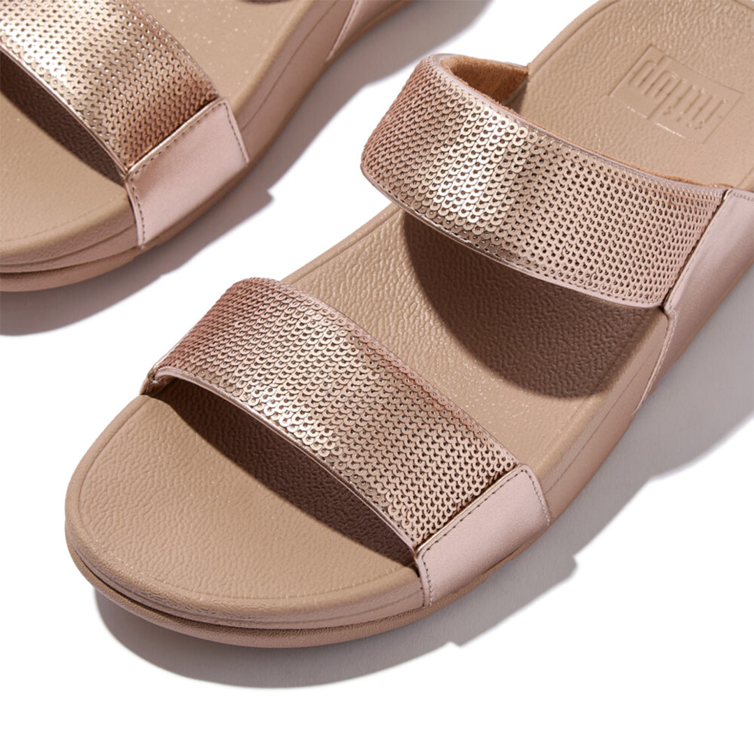 LULU sequin slides with padded uppers, Microwobbleboard™ cushioned footbed, metallic side panels, and sparkling sequins.