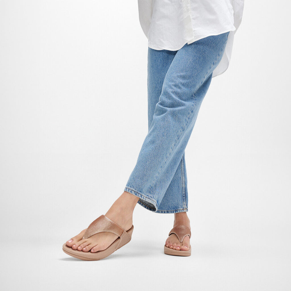 LULU sequin toe-post sandals with padded uppers, Microwobbleboard™ cushioned footbed, metallic side panels, and sparkling sequins.