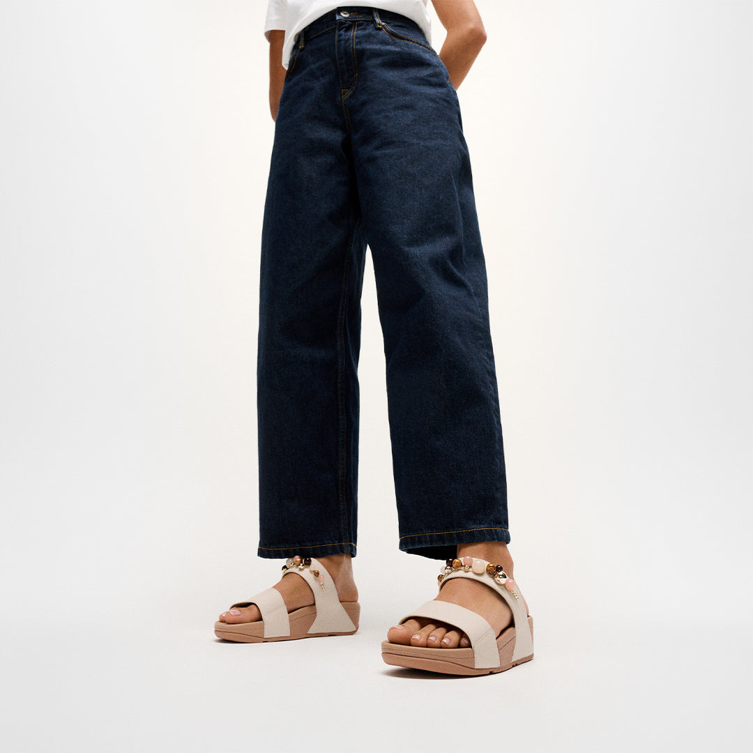 Woman wearing FitFlop LULU Beaded Slides with embellished leather straps and supportive cushioned sole.