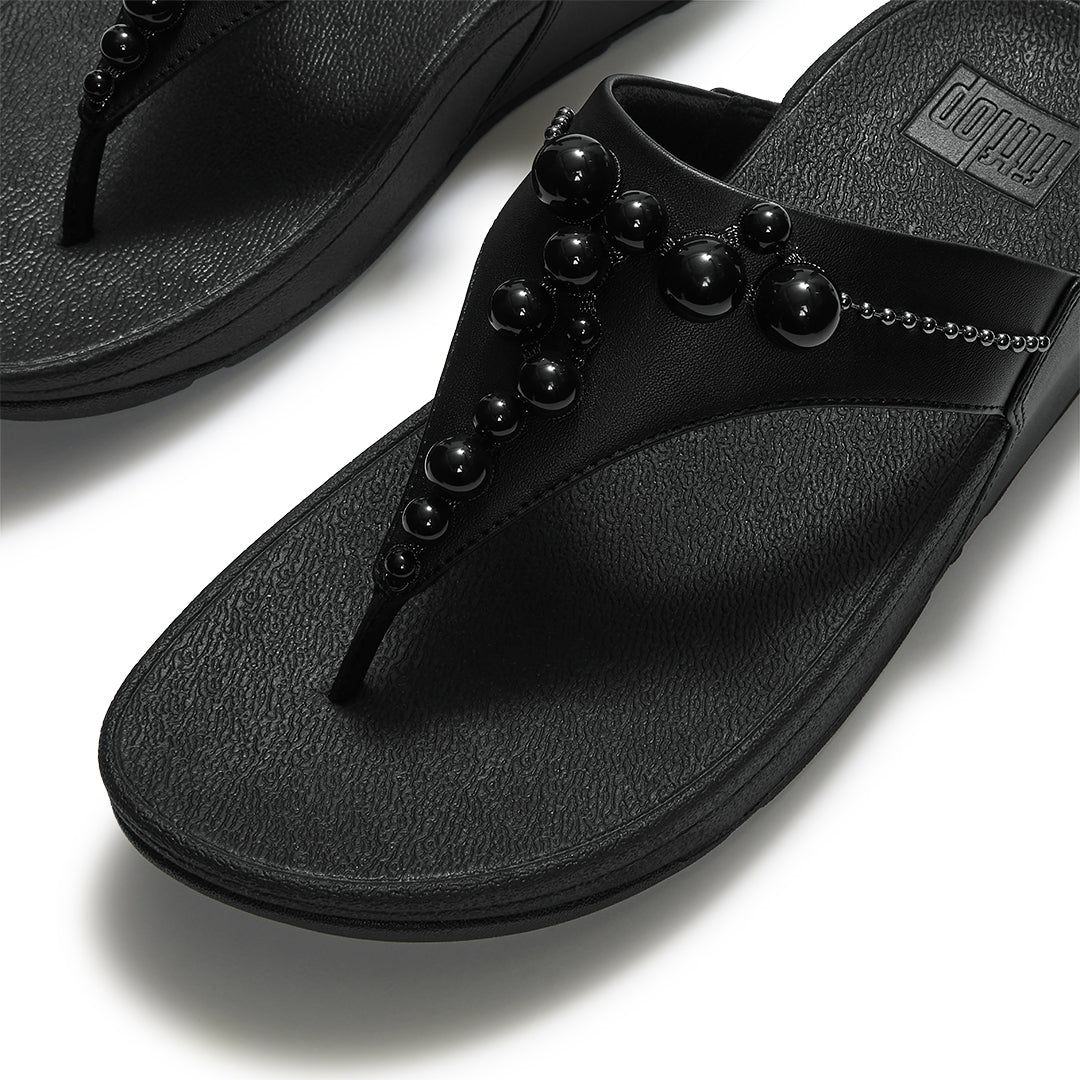 Close-up of FitFlop LULU Beaded Toe-Post Sandals showcasing tonal metallic and resin bead embellishments across the triangular vamp.
