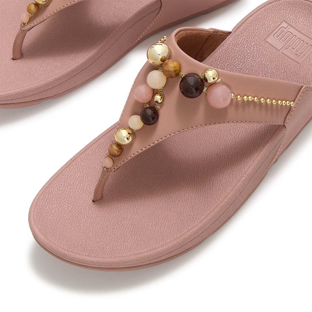 Close-up of FitFlop LULU Beaded Toe-Post Sandals showcasing tonal metallic and resin bead embellishments across the triangular vamp.