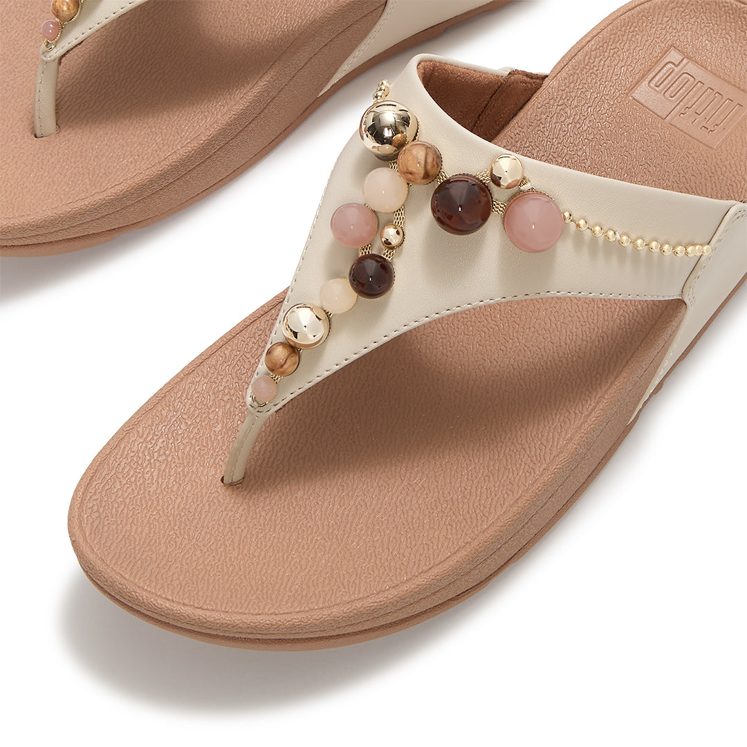 Close-up of FitFlop LULU Beaded Toe-Post Sandals showcasing tonal metallic and resin bead embellishments across the triangular vamp.