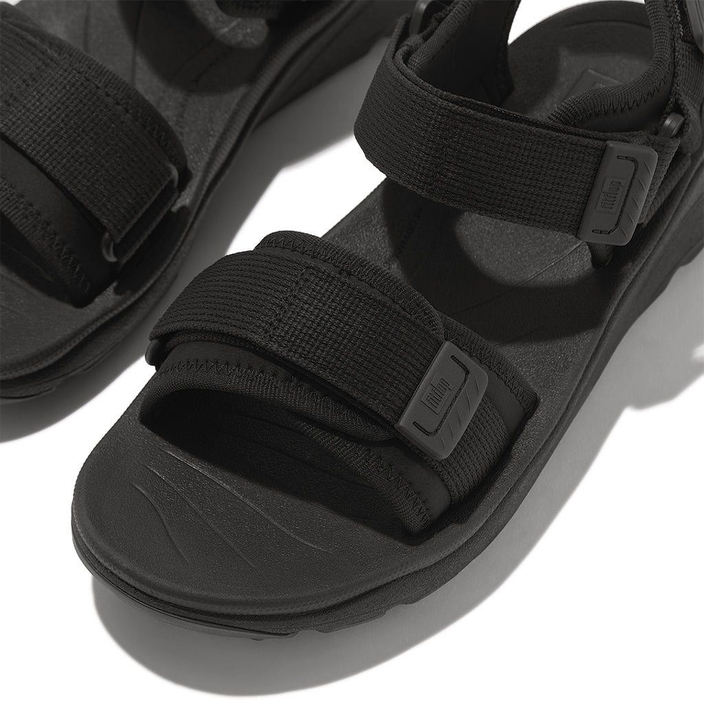 Close-up of FitFlop NEO-D-HYKER Outdoor Sandals featuring water-resistant webbing straps, TPU strap ends, and secure fastening system.