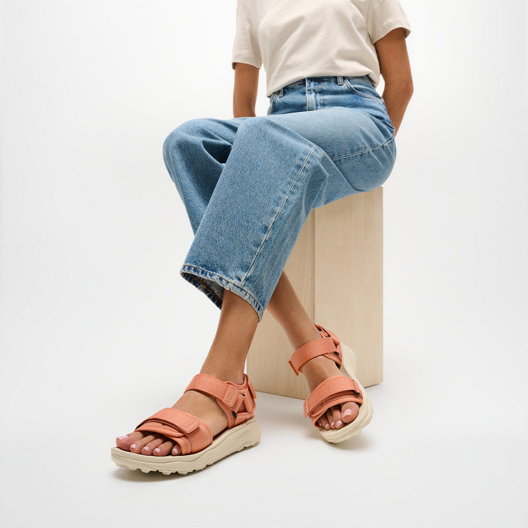 Person wearing FitFlop NEO-D-HYKER Outdoor Sandals featuring adjustable straps, ergonomic cushioning, and durable outdoor traction.