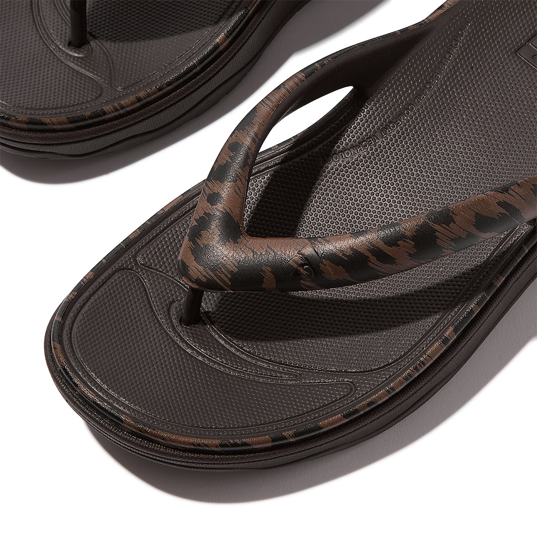 Close-up of FitFlop RELIEFF Leopard Recovery Toe-Post Sandals featuring soft EVA construction and all-over leopard-print detailing.