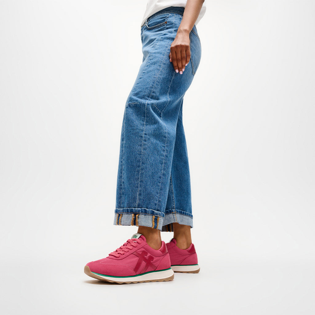 Woman wearing FitFlop RETRO-Q FF Sneakers with vintage-inspired styling, premium suede panels, and lightweight cushioned comfort.